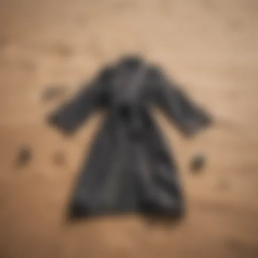 Stylish beach changing robe laid out on sand