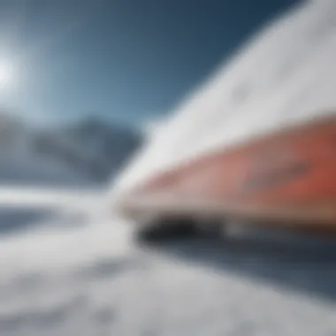 A close-up of a snowboard with unique design patterns resting on fresh snow.