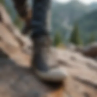 A person engaging in rock climbing while wearing Chuck Taylor slip resistant shoes