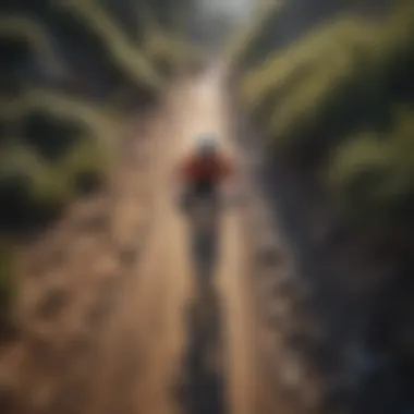 An aerial view of a mountain biker navigating a rugged trail.