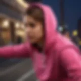 Dynamic athlete showcasing a hot pink hoodie during a thrilling skateboarding trick.