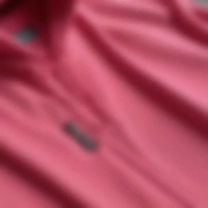 Close-up of high-performance fabric of a hot pink hoodie designed for outdoor activities.