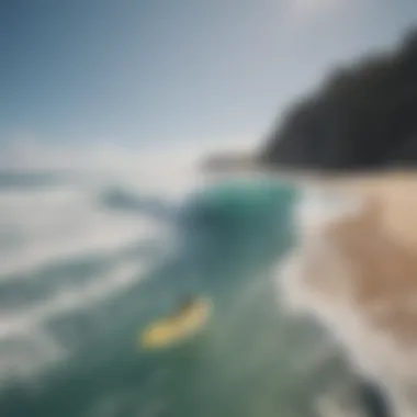 An aerial shot of surfers catching waves at a pristine beach