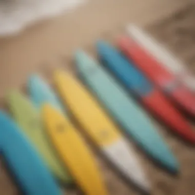 An aerial shot of several fiberglass surfboards lined up on the beach, showcasing their variety and sizes under the sun.