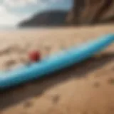 Variety of paddle boards displayed on a sandy beach