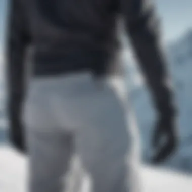 A side view of a skier adjusting the fit of Gerry ski pants, demonstrating the importance of a tailored fit.