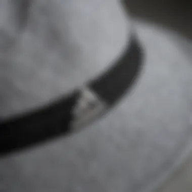 Close-up view of the grey Adidas bucket hat highlighting its fabric texture