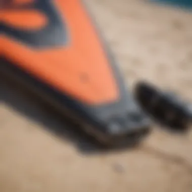 Close-up of kite surfing gear laid out on the beach