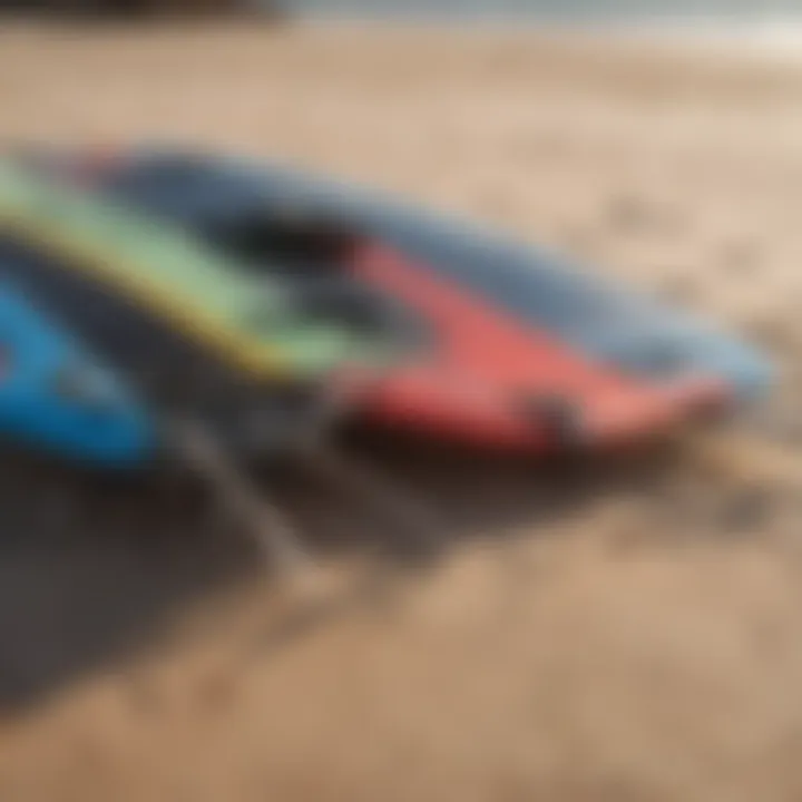 A close-up of kite surfing equipment laid out on the sandy beach, including kites and boards.