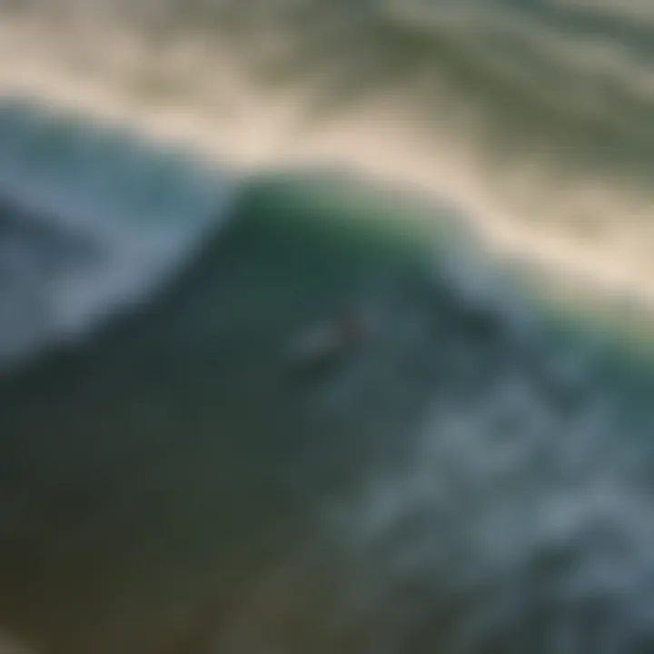 A stunning overhead view of surfers riding waves at a popular beach in Florida.