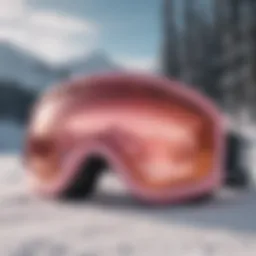 Stylish pink snow goggles on a snowy landscape