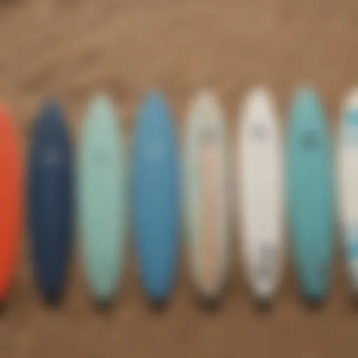 A selection of small wave surfboards lined up on the beach showcasing different designs and colors.