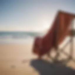 A surf poncho draped over a beach chair with waves in the background