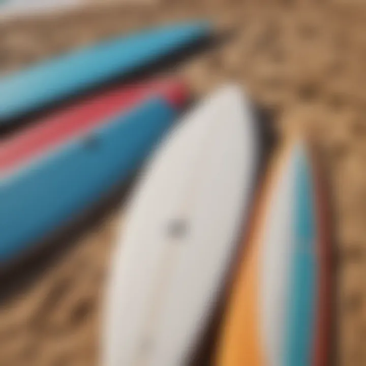 Close-up of surfboards lined up on the sandy beach