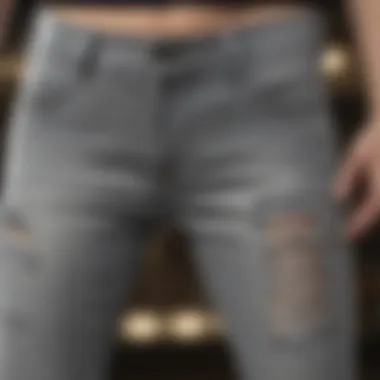 Detailed view of the fabric and design of grey ripped skinny jeans