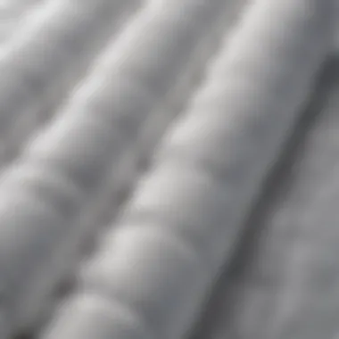 Luxurious Texture of the White Puffer Jacket A close-up view of a luxurious white puffer jacket showcasing its texture and stitching.