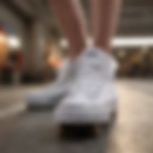 All white high top Chuck Taylor sneakers resting on a skateboard