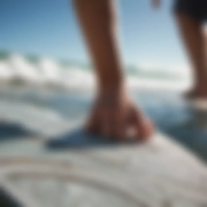 A person cleaning and maintaining a surfboard traction pad