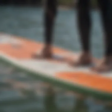 Demonstration of proper placement of a traction pad on a surfboard