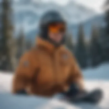 Tan snowboard bibs displayed against a snowy backdrop